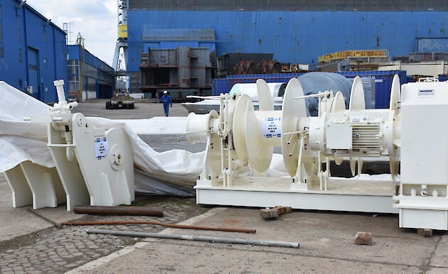 A winch to winch ropes used to moor the ship, waiting to be installed.