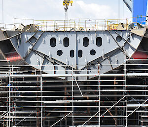 The bow of the ship with ‘anchor pockets’ (recesses to house the anchors) visible on each side of the ship.
