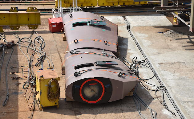 Two rudders waiting to be installed on the ship.