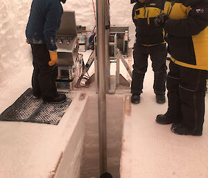 Ice core drill inside its weather haven covered ice pit