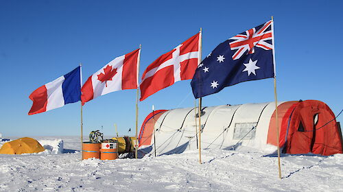 Mount Brown South ice core drill camp showing weather haven tent over the drill site, and international flags of the participating countries