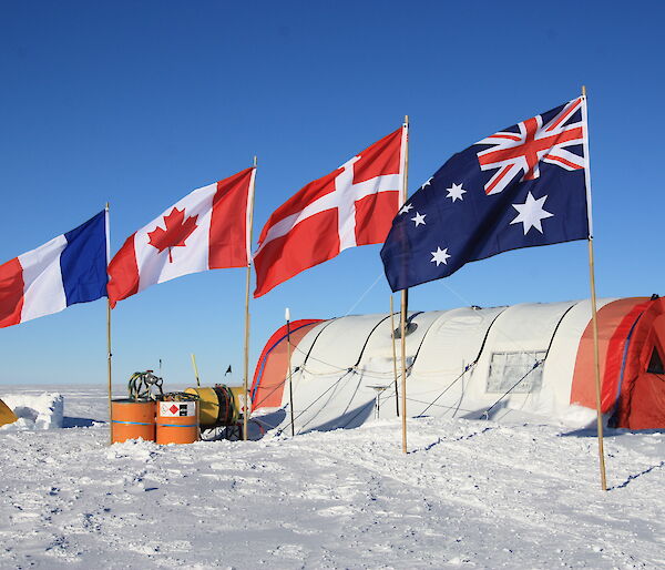 Mount Brown South ice core drill camp showing weather haven tent over the drill site, and international flags of the participating countries