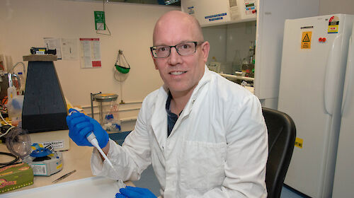 Dr Bruce Deagle with a test tube in his laboratory.