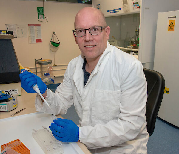 Dr Bruce Deagle with a test tube in his laboratory.