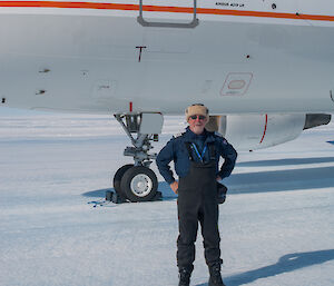 Man standing in front of aeroplane on ice