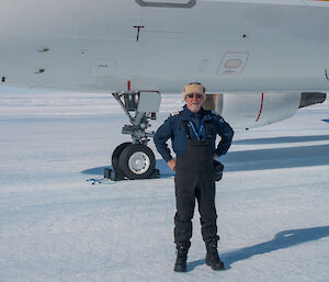 Man standing in front of aeroplane on ice