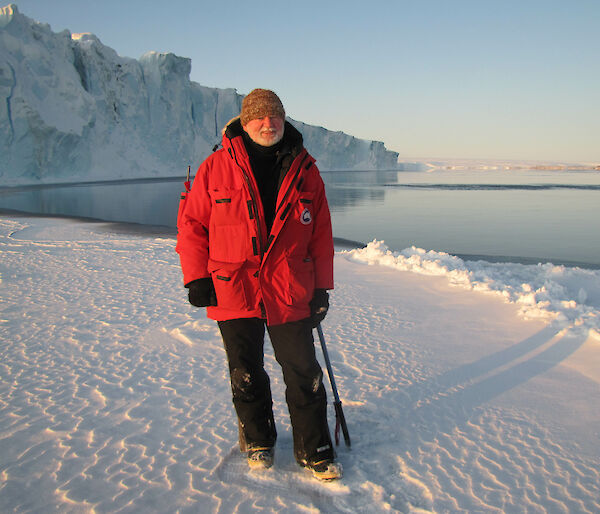 Man standing on ice in red jacket