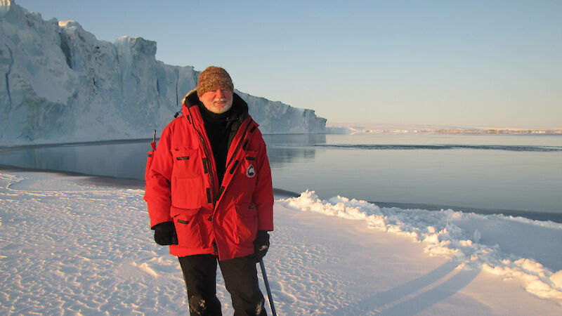 Man standing on ice in red jacket