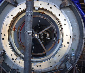 A crosshair frame with its laser target point (the bronze cap at centre of frame), mounted in a sterntube bearing, during alignment checks of the sterntube inside the gondola.