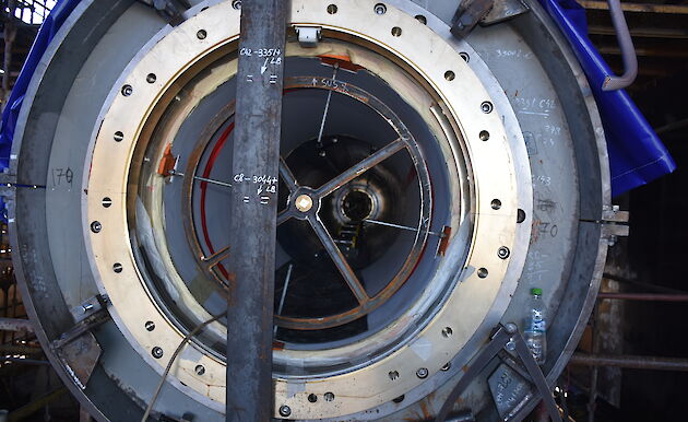 A crosshair frame with its laser target point (the bronze cap at centre of frame), mounted in a sterntube bearing, during alignment checks of the sterntube inside the gondola.