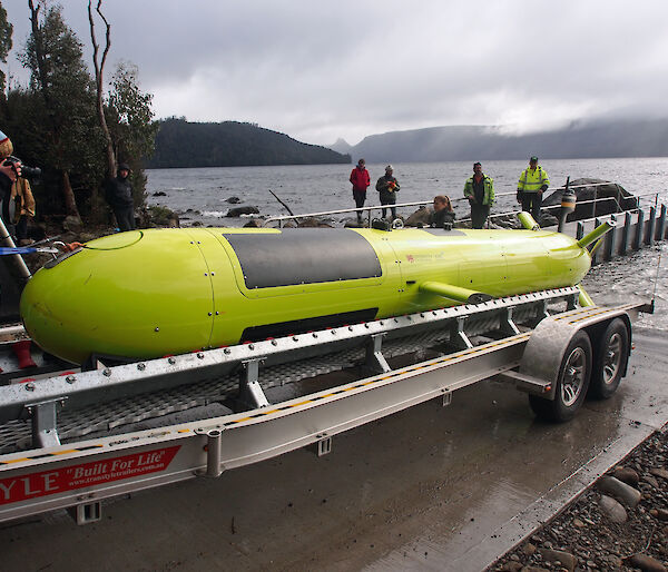 The 7 metre long yellow autonomous underwater vehicle on a trailer backing into Lake St Clair.