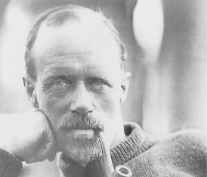 Black and white portrait of a man with a pipe in his mouth