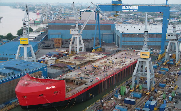 The RSV Nuyina floating in the dry dock with strops attached to buoyancy bags running down the ship’s sides.