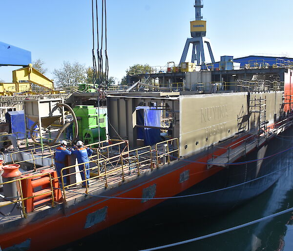 The Nuyina’s name panel is in place above the watertight hull, as other components of the superstructure (area above the hull) are being prepared for installation.