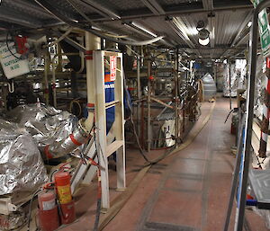Cables and pipework being installed in an engine room.