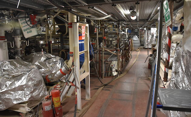 Cables and pipework being installed in an engine room.