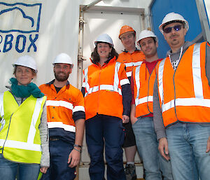 Group of team members outside AIRBOX on ship