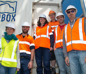 Group of team members outside AIRBOX on ship