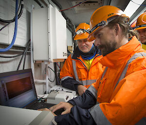 Jeff Aquilina (left), Steele Griffiths (front) and Juarez Viegas from the US Atmospheric Radiation Measurement program monitor radiosonde data during a flight.