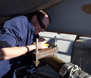Mike clamping the fuel line during leak testing.