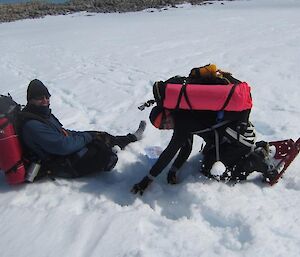 Expeditioners trying to retrieve the boot from the snow