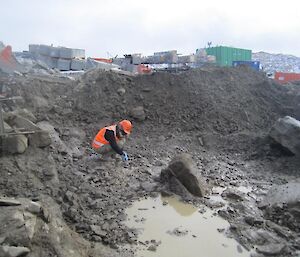 Bec taking a soil sample from the base of the excavated area.