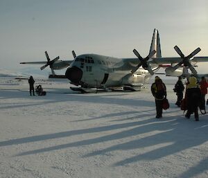 Expeditioners getting off a Hercules aircraft