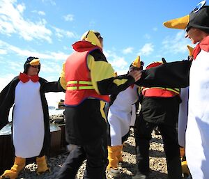 Expeditioners dressed in penguin suits