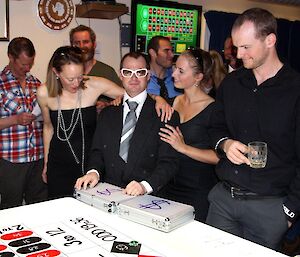 Expeditioners dressed like James Bond for the high roller during the casino night