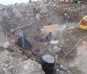 Preparing for blinding and drilling starter bars into the rock to support the piers. Mark Gallagher on the left, Paul Tuplin on the electric jack hammer and Andrew Fitzsimmons on the rock drill