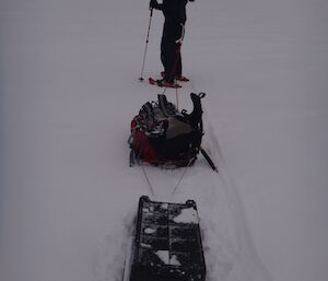 Craig on the snow with sled in foreground