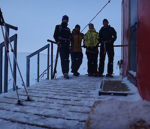 Sled hauling at Robbo’s, group shot outside the red hut