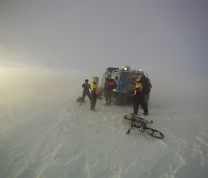 Expeditioners getting back into Hagg with dark cloud cover overhead