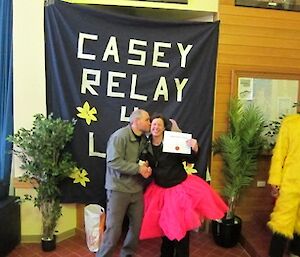 Relay for Life. Misty receives a certificate, a bottle of wine and a kiss on the cheek for her fundraising efforts