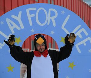 Relay for Life. Craig poses at hand-painted finish-line arch