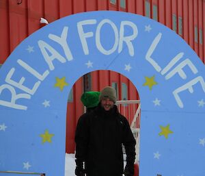 Relay for Life. Jason poses at hand-painted finish-line arch