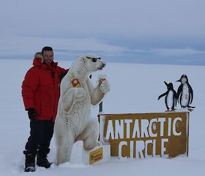 Jason Blackwell at Antarctic Circle sign