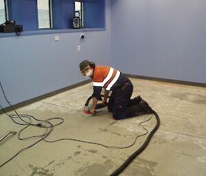 Trades office Casey showing expeditioner prepping the floor for new carpet