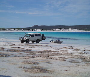 A photo of Mike Kennard and some of his toys from home: a boat and 4WD