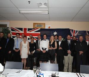 Group shot of midwinter dinner guests dressed up