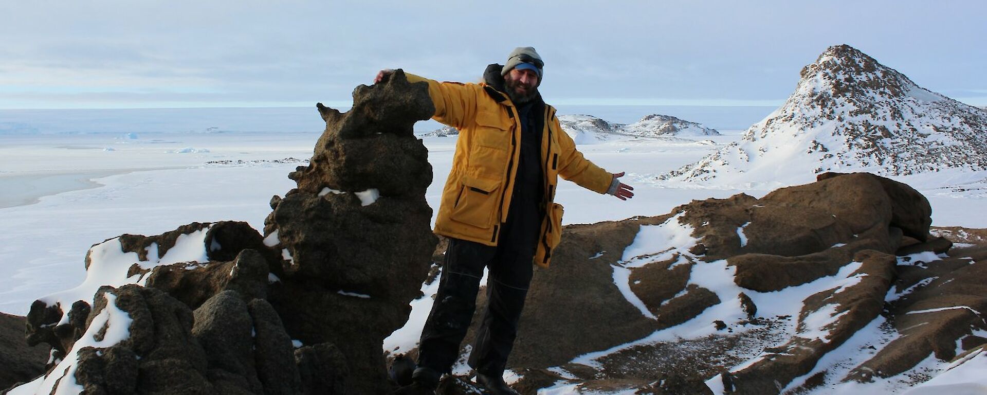 Mark Grainger at Browning Peninsula surrounded by rocks and snow