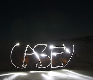 Stuart writes Casey in the snow with his head torch