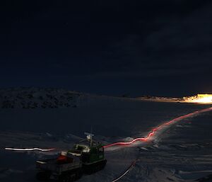 Mike on a quad heading to the upper fuel farm at night