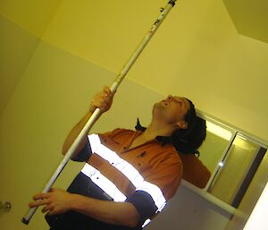 Dan painting the bathroom ceiling