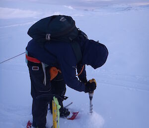 Craig drilling sea ice in Sparkes Bay