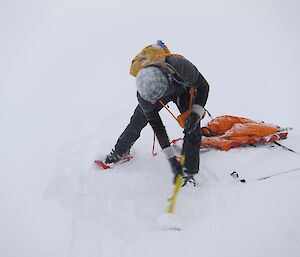 Stu clearing away the snow so he can drill the sea ice