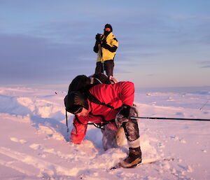 Sheri photographing a skier who has fallen over