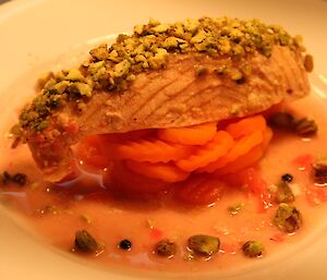 Pistachio crusted salmon poached in pickled ginger with sauteed carrots
