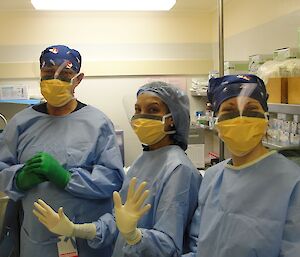Gloved and gowned — Doc Sheri (centre) with Dave and Bri