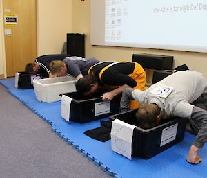 Casey Olympics event showing expeditioners with heads in buckets of water